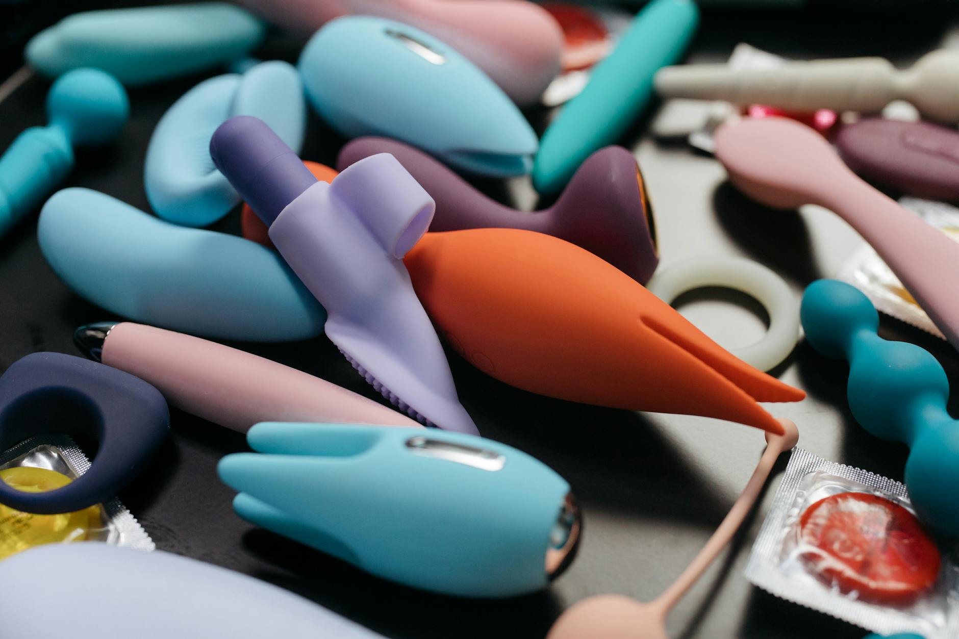 A vibrator surrounded by flowers and citrus on a bright background, symbolizing pleasure-focused intimacy