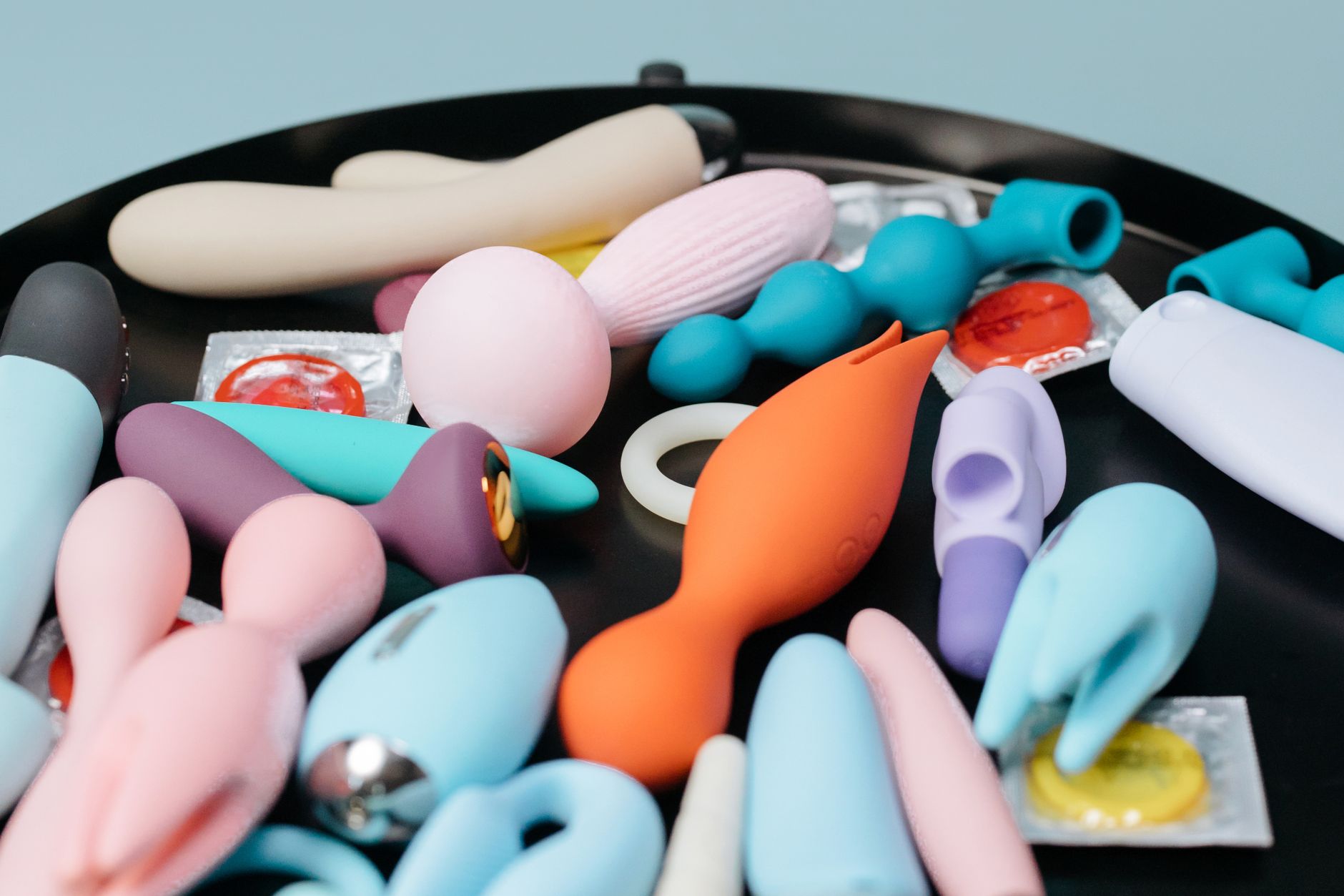 A vibrant collection of lemon sexual toys and vibrators on a black surface